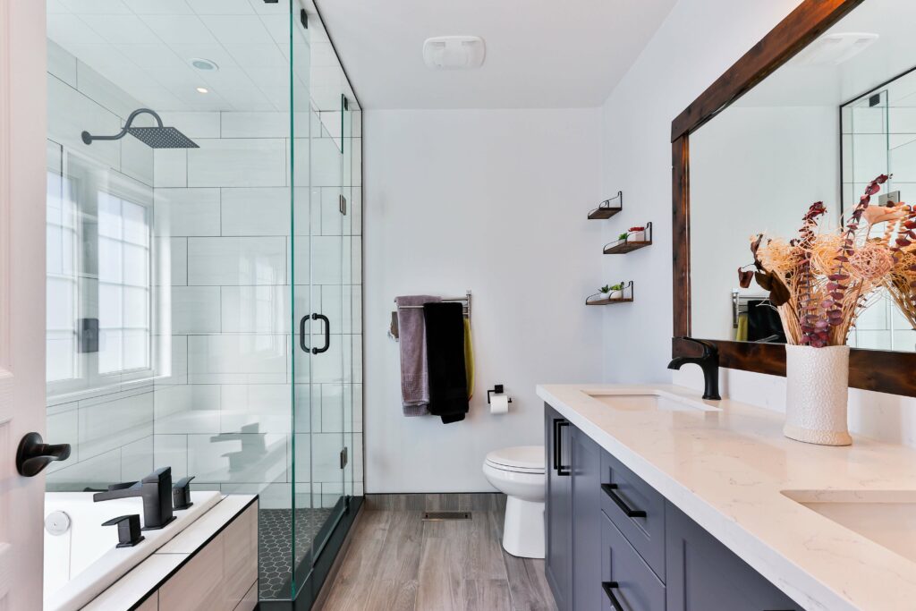 a clean bathroom with tub, shower, and counter
